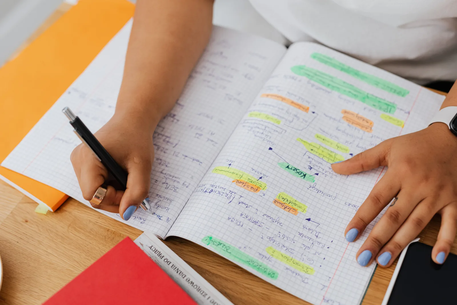 A person writing and highlighting notes in a graph notebook. Ideal for education and productivity themes. How to assess campaign measurement benchmarks