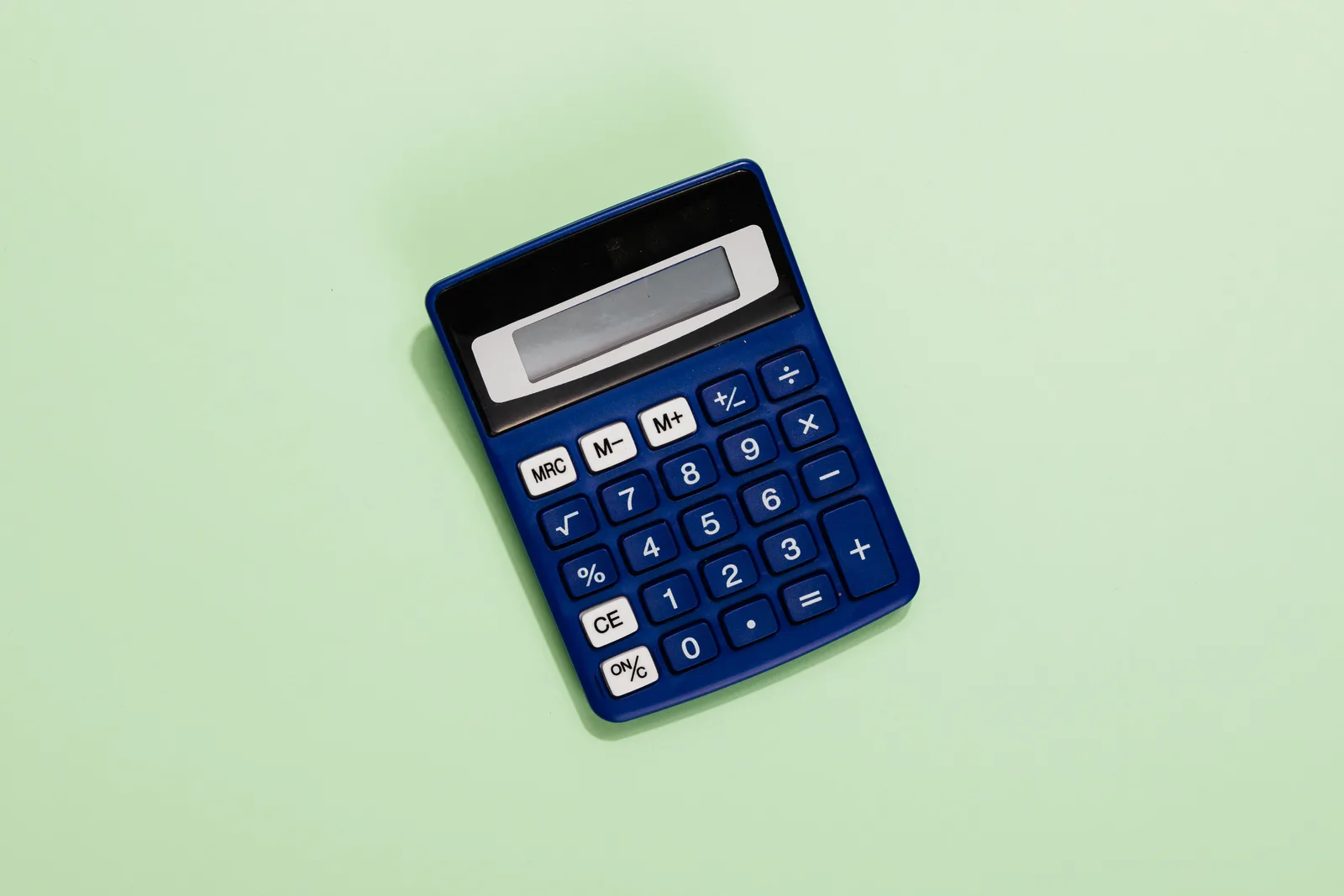 A blue calculator placed on a light green background. Ideal for financial and educational themes. Common marketing KPIs questions and answers