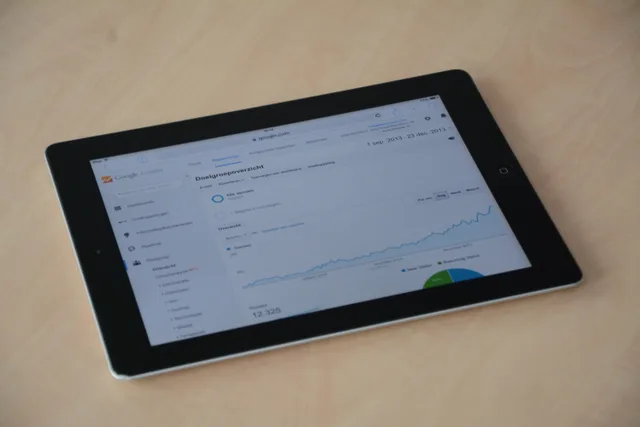 A digital tablet showing a web analytics dashboard with graphs and charts. GA4 DebugView for Web Analytics: What an Event Test Proves