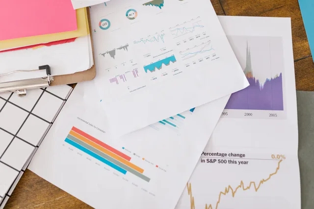 Close-up of business analytics charts and graphs on papers and clipboard. Marketing KPIs Checklist for Retiring an Old Metric