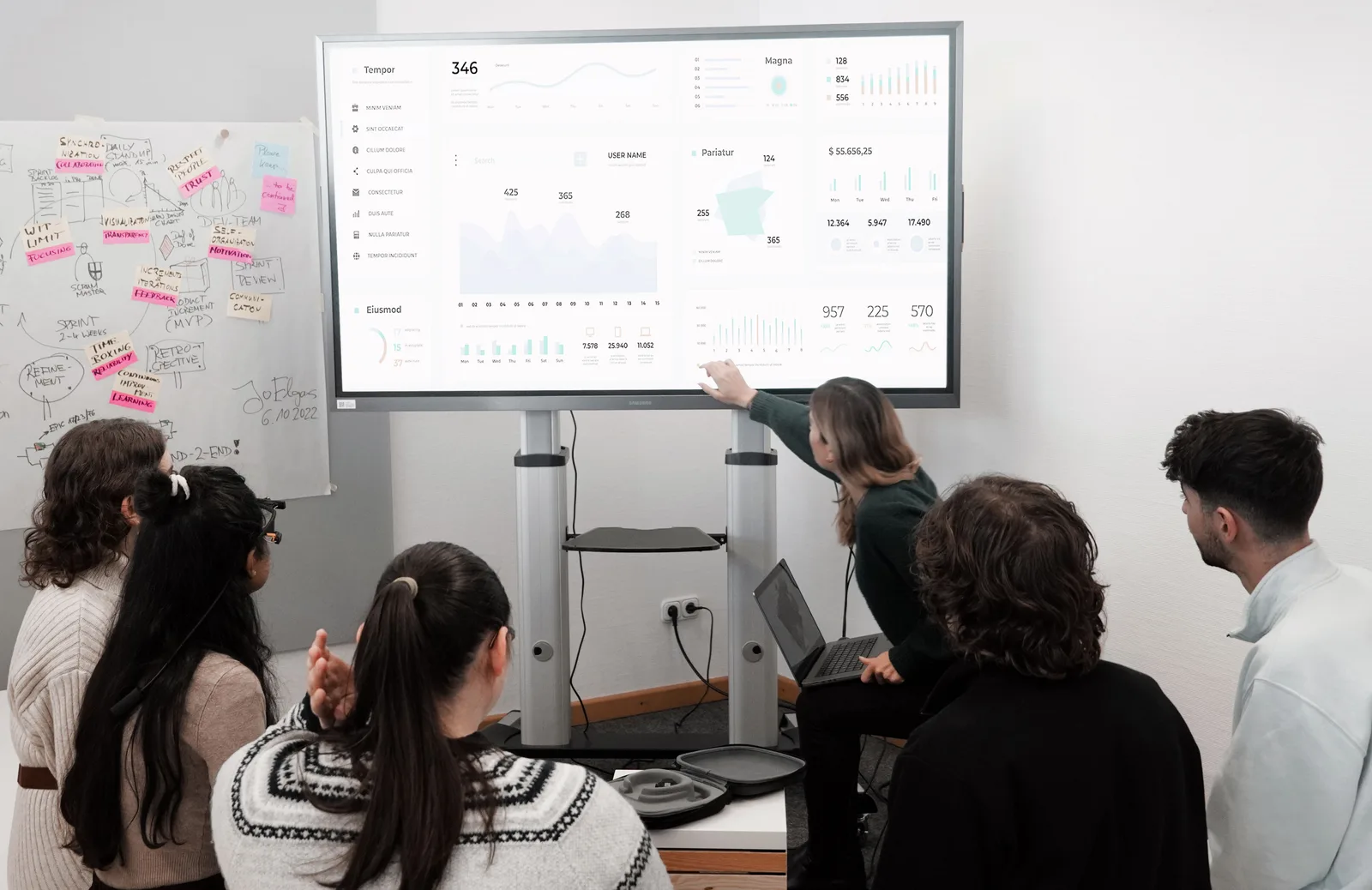 Group of professionals engaged in a business presentation examining charts on a large screen. Where marketing mix models go wrong: patterns worth catching early