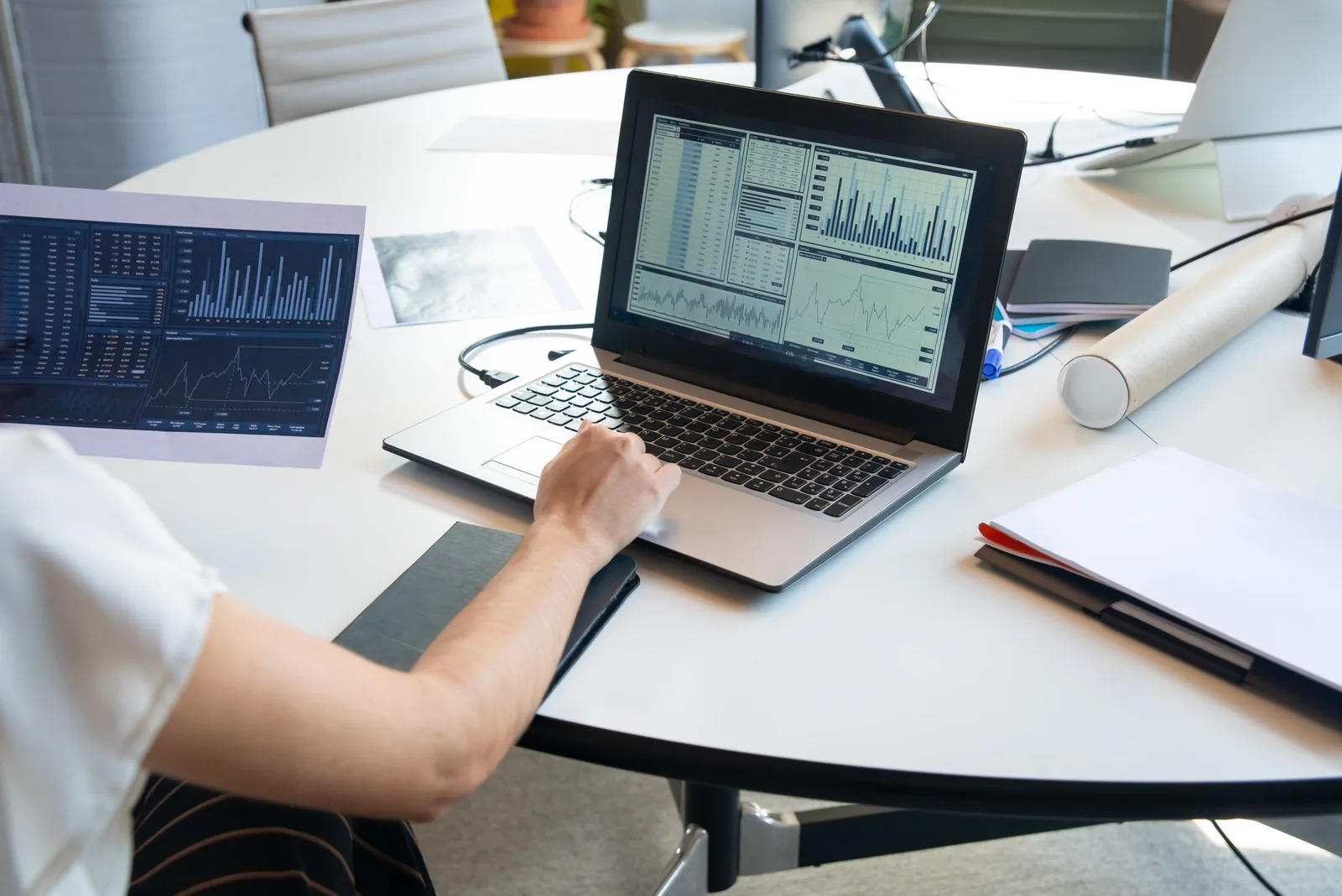 Business person evaluating financial charts on a laptop in a modern office setting. How to think about marketing mix modeling trends, updated for 2027